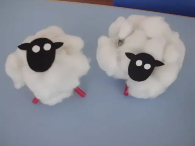 Two handmade sheep models created with white cotton and paper shapes.