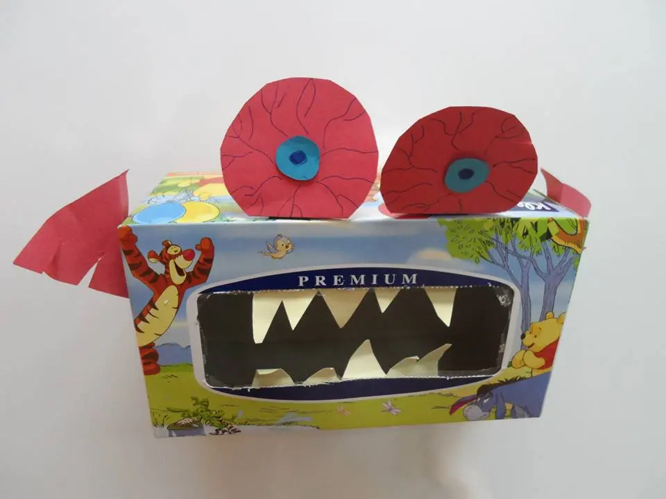 Handmade monster craft created from a decorated cardboard box.