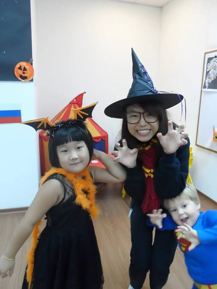 Children and adult dressed in playful Halloween costumes.