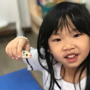 探究型学習の中で工作の作品を持つキンダーガーテン1の子ども